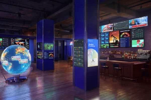 Polymarket opens Washington bar for watching geopolitics markets and breaking news. Polymarket Situation Room bar interior with global data screens prediction markets dashboards and illuminated world globe display in Washington DC.
